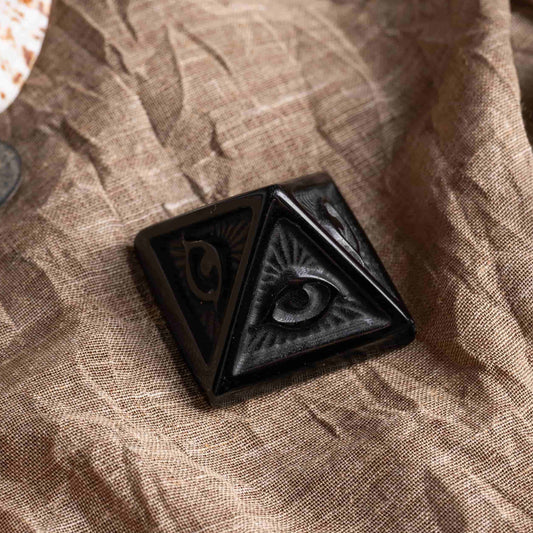 Close-up of all seeing eye pyramid evil design with polished stone finish.