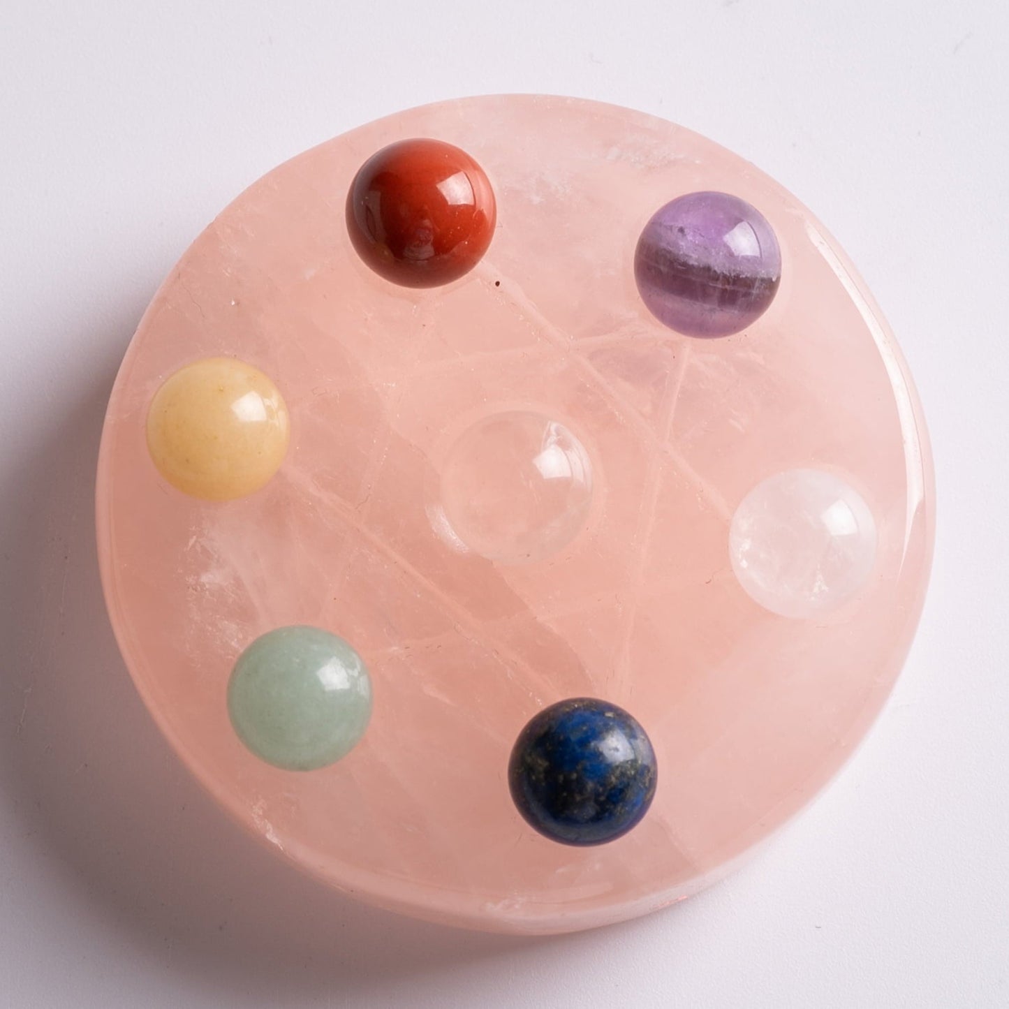 Chakra gemstones held in hands, symbolizing love, harmony, and healing energy.