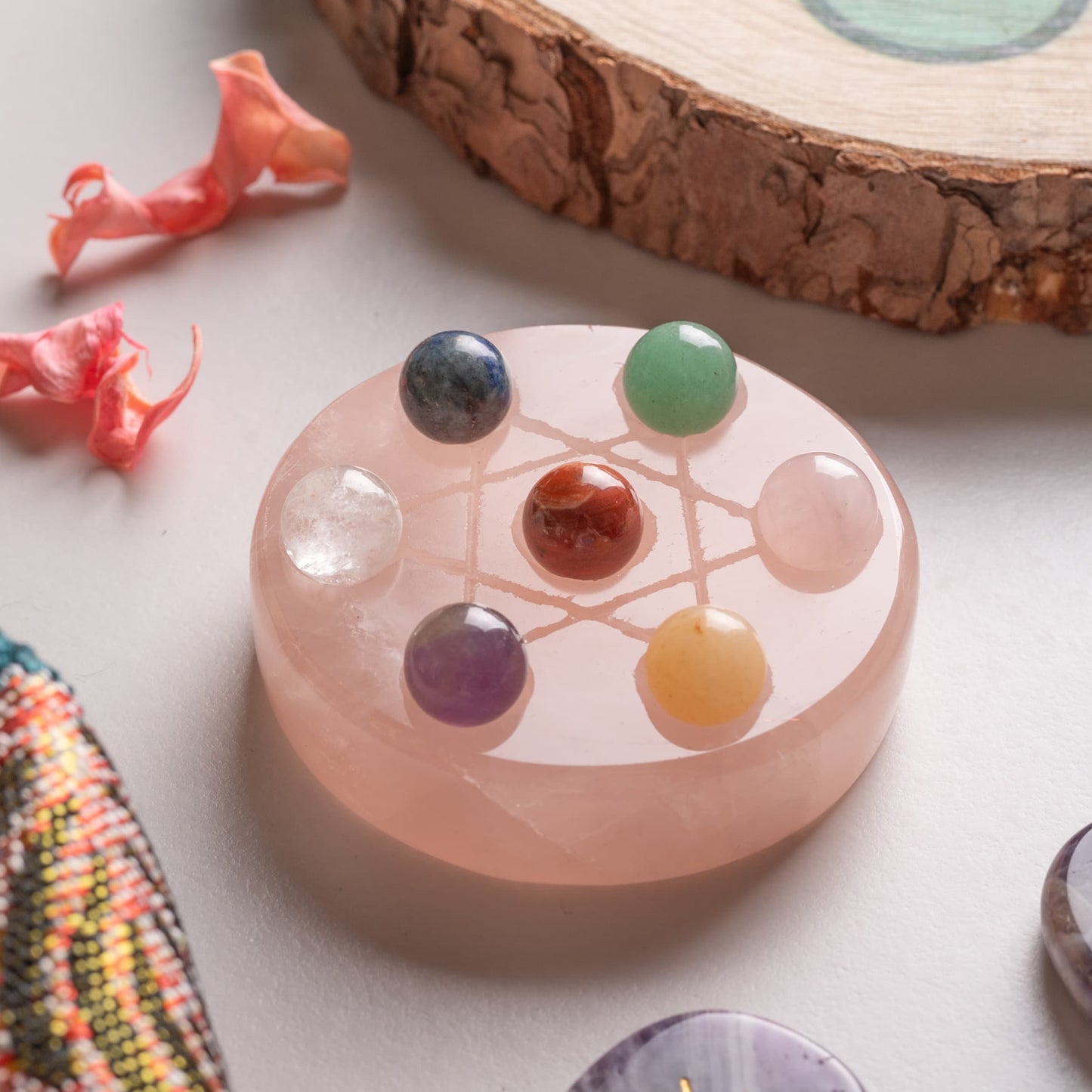 Close-up of chakra healing stones, including amethyst, jasper, and quartz.