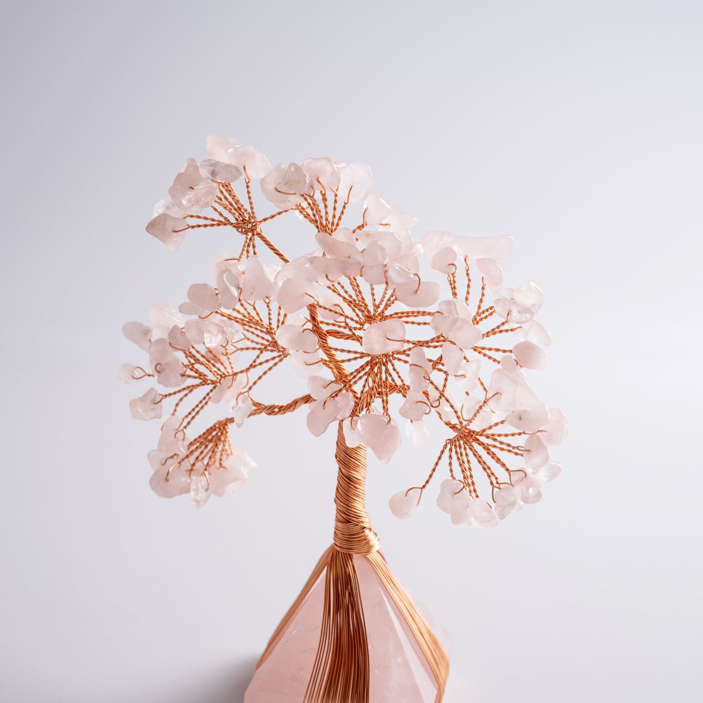 Crystal money tree placed on desk, attracting positive energy, love, and good fortune in feng shui practice.