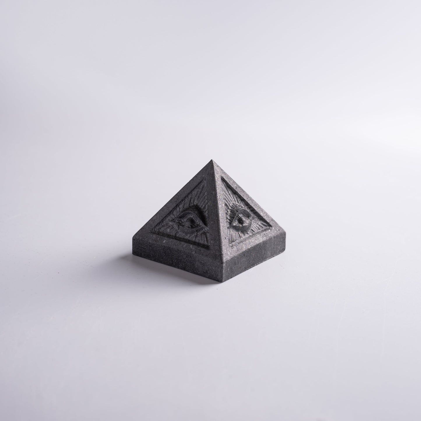 Evil pyramid with all seeing eye held in hand, symbol of wealth and success.