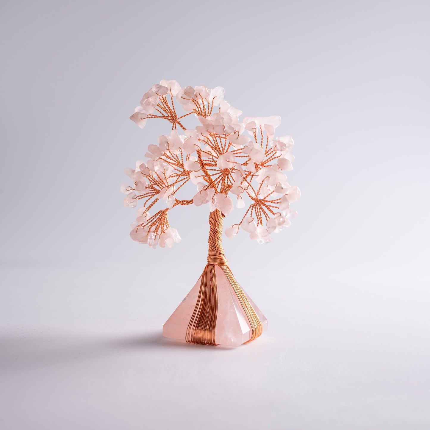 Side view of handcrafted gemstone tree with jade and quartz crystals, elegant spiritual home ornament.