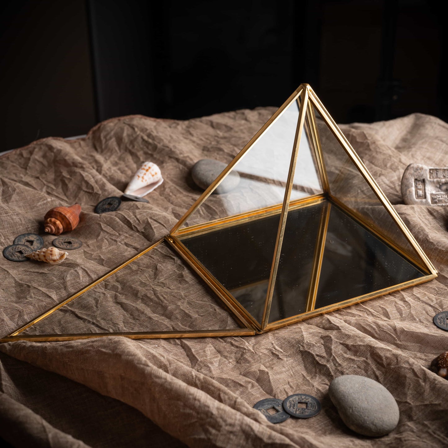 Lucky brass pyramid charging box with reflective glass surface, sacred energy tool.