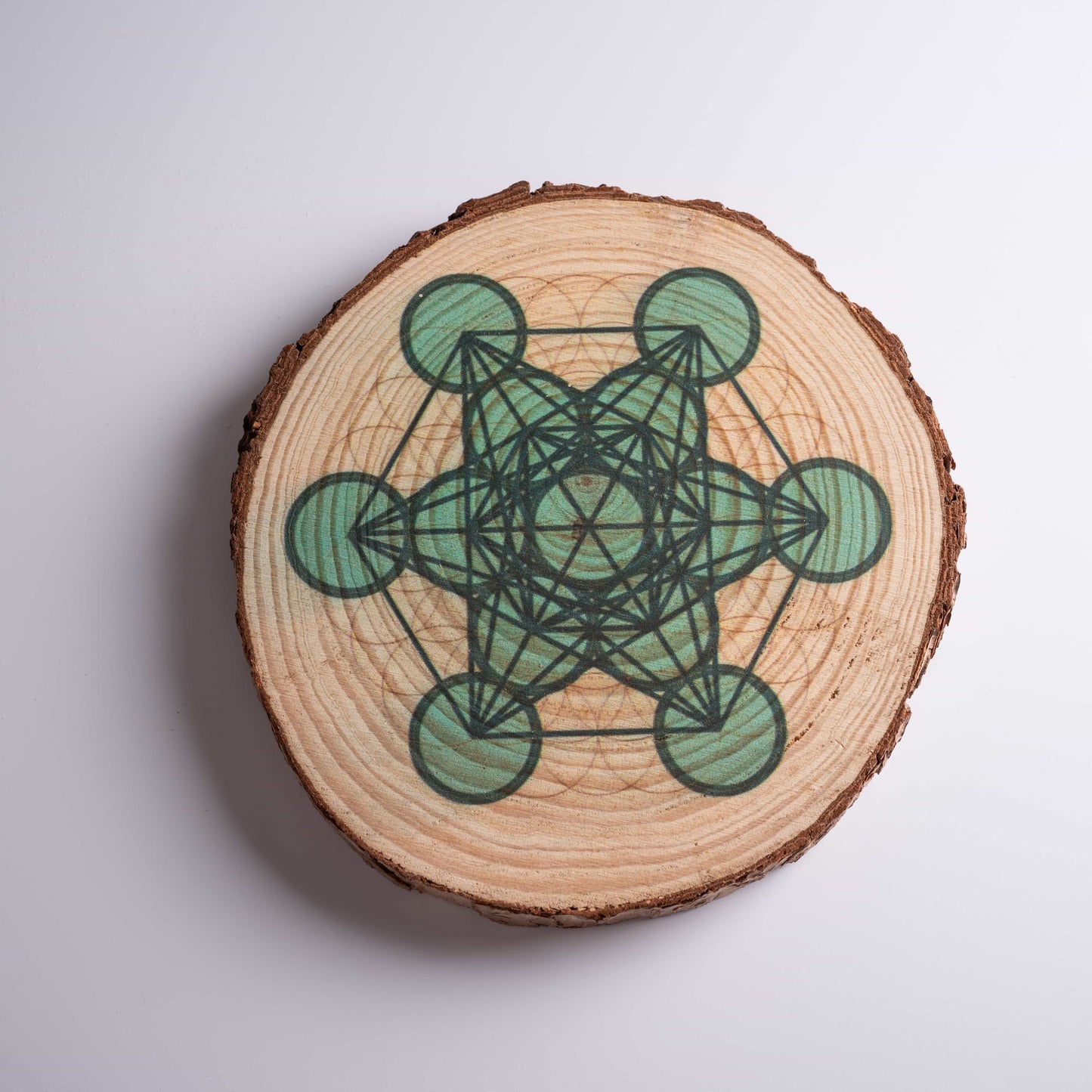 Close-up of laser-engraved Metatron's Cube art on crystal grid board for healing.