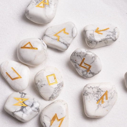 Close-up of runes crystal engraved with intricate golden gypsy symbol.