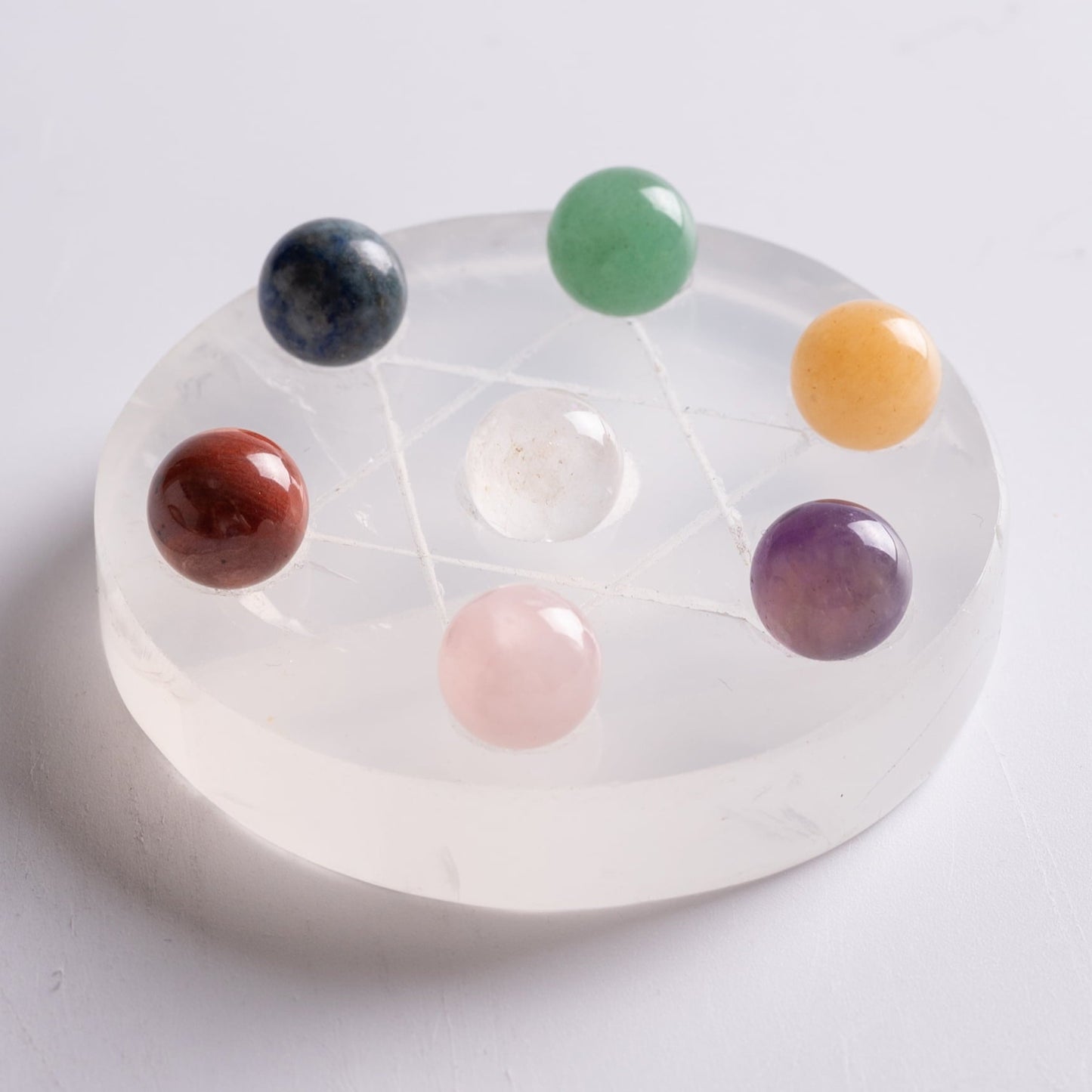 Stones for chakra healing displayed on altar for spiritual practice.