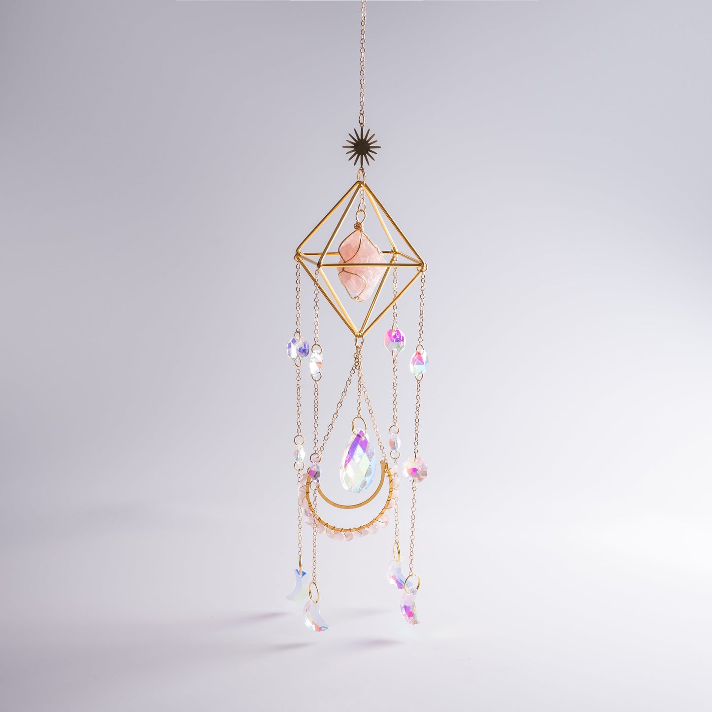 Window crystal suncatcher casting colorful light across a sacred space.