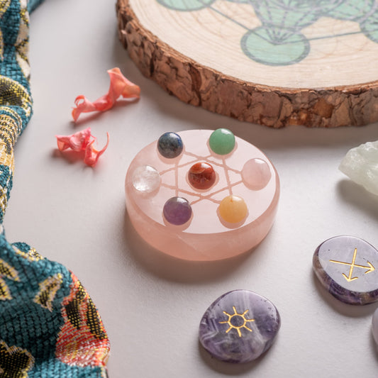 7 chakra stones set on hexagram stand, polished gemstones in vibrant colors.