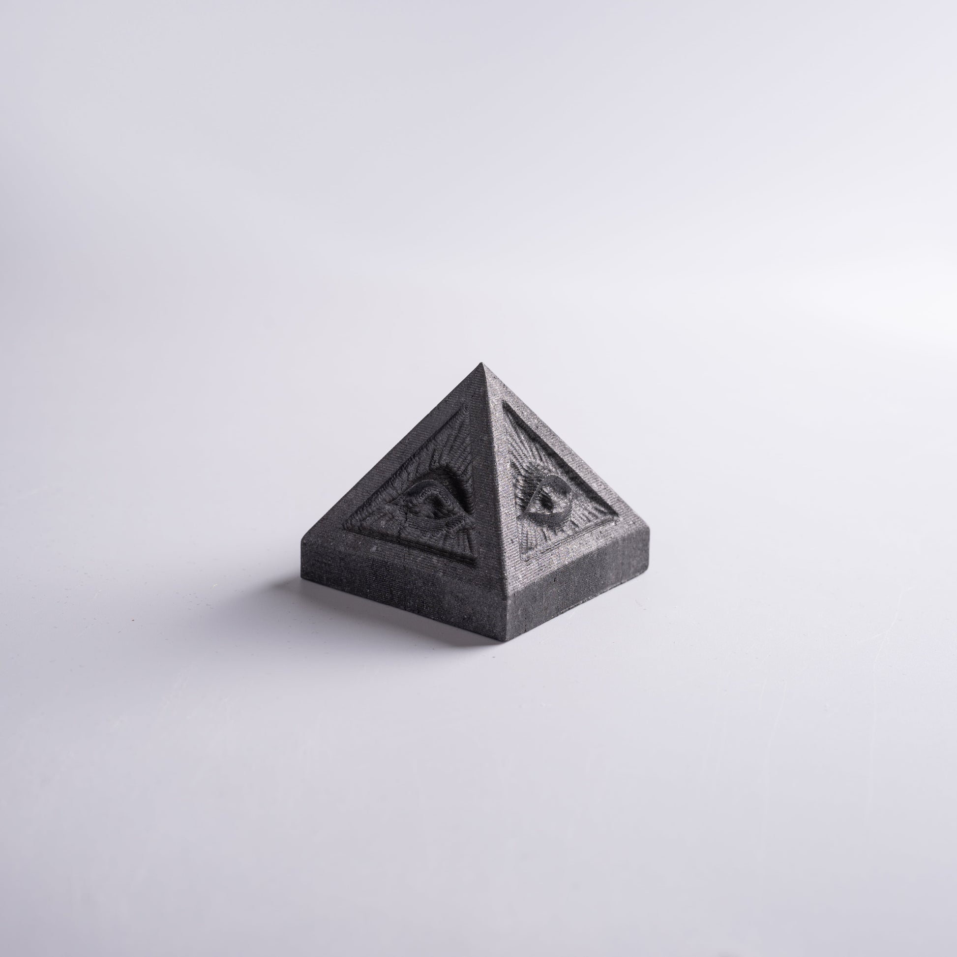 Evil pyramid with all seeing eye held in hand, symbol of wealth and success.