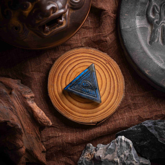 Close-up of Eye of Horus amulet engraved on quartz crystal, showcasing ancient Egyptian symbols.