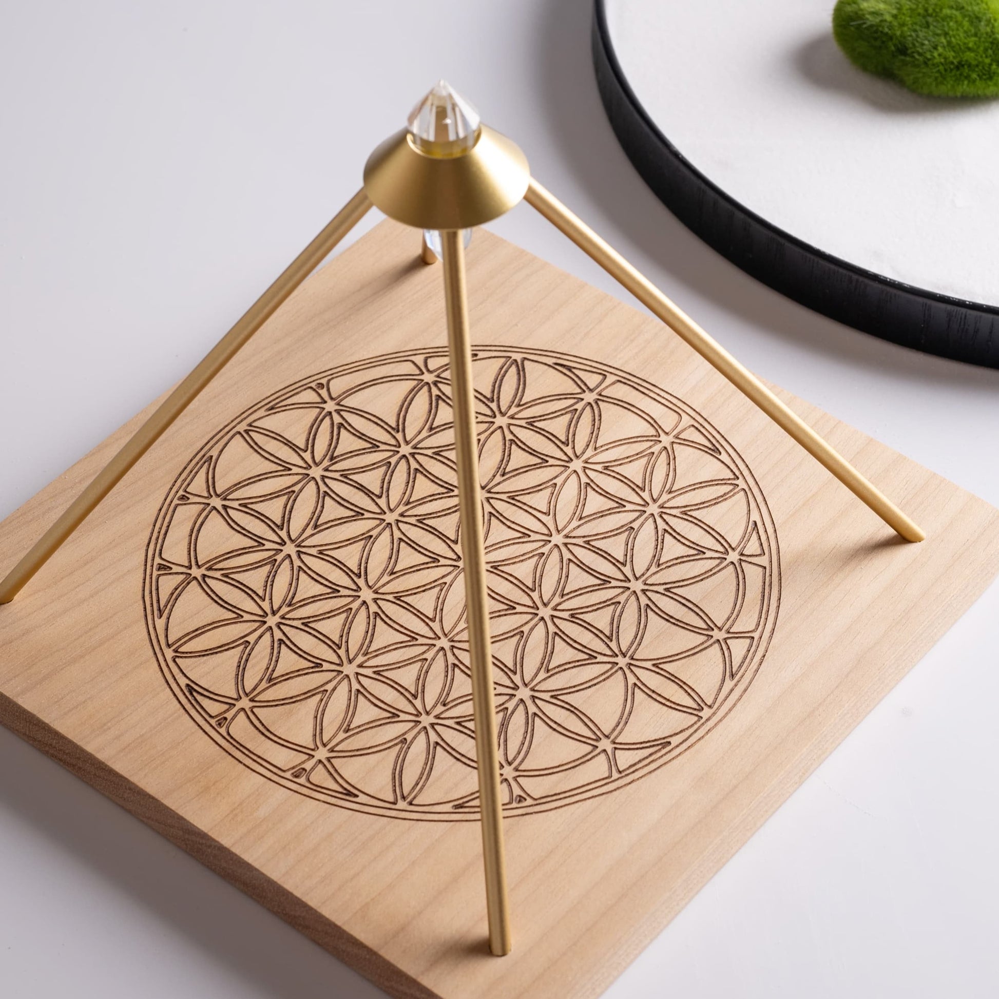 Flower of Life crystal grid board with crystals arranged for energy healing.