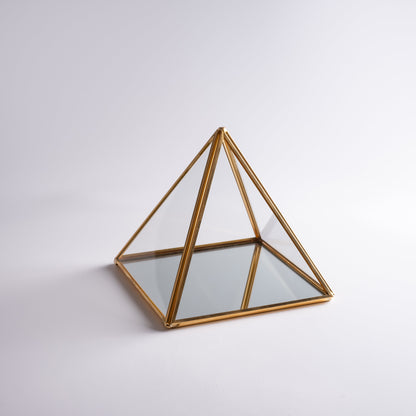 Glass pyramid jewelry box used to store and display precious items.