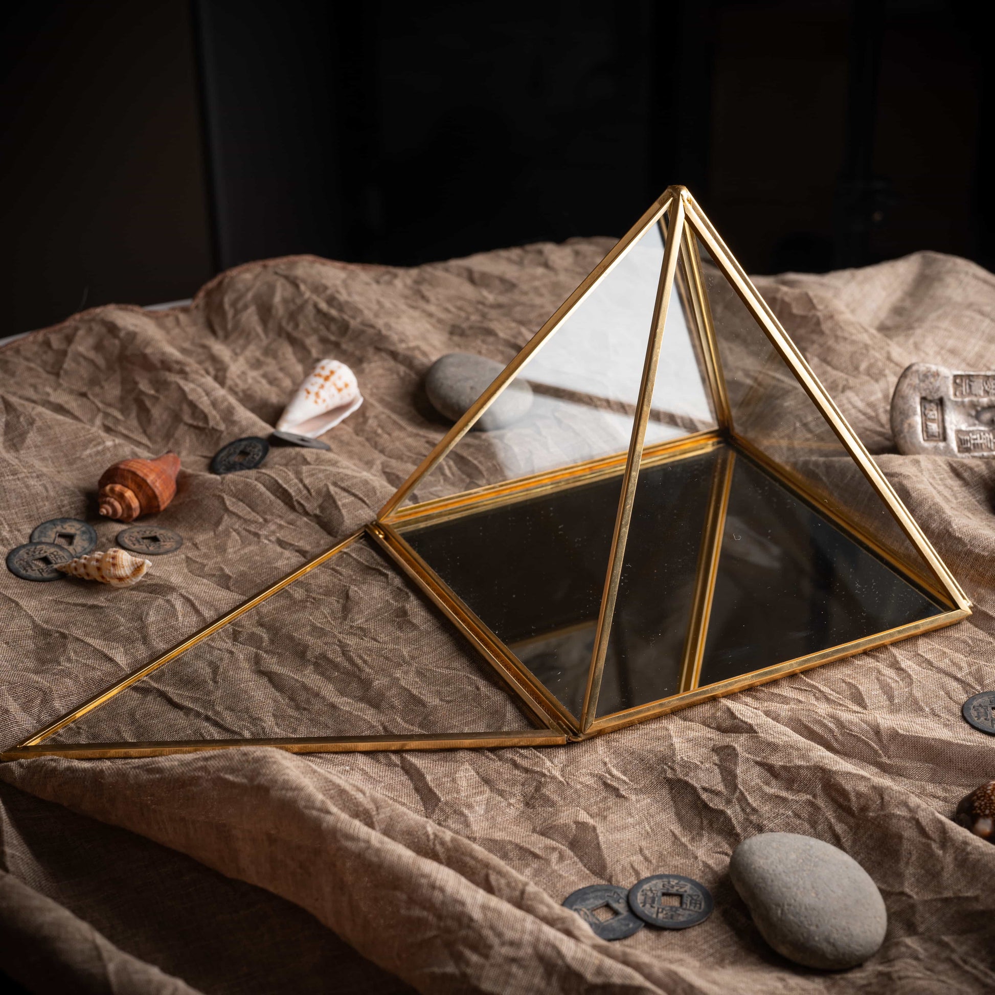 Lucky brass pyramid charging box with reflective glass surface, sacred energy tool.