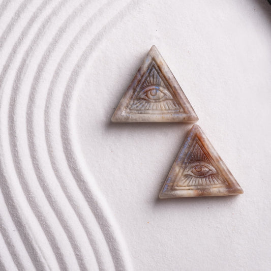 Quartz crystal Eye of Horus pendant worn for focus and spiritual protection.