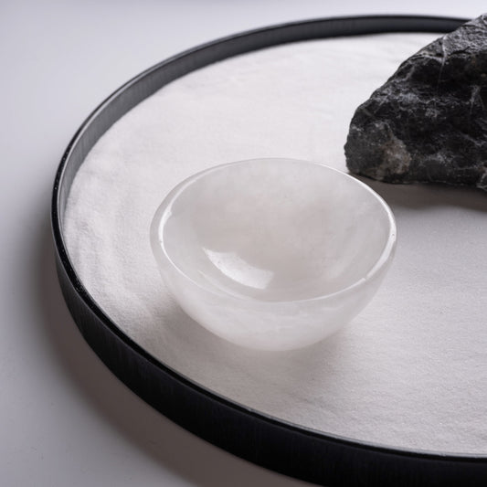 Hand-carved selenite charging bowl with natural white textures.