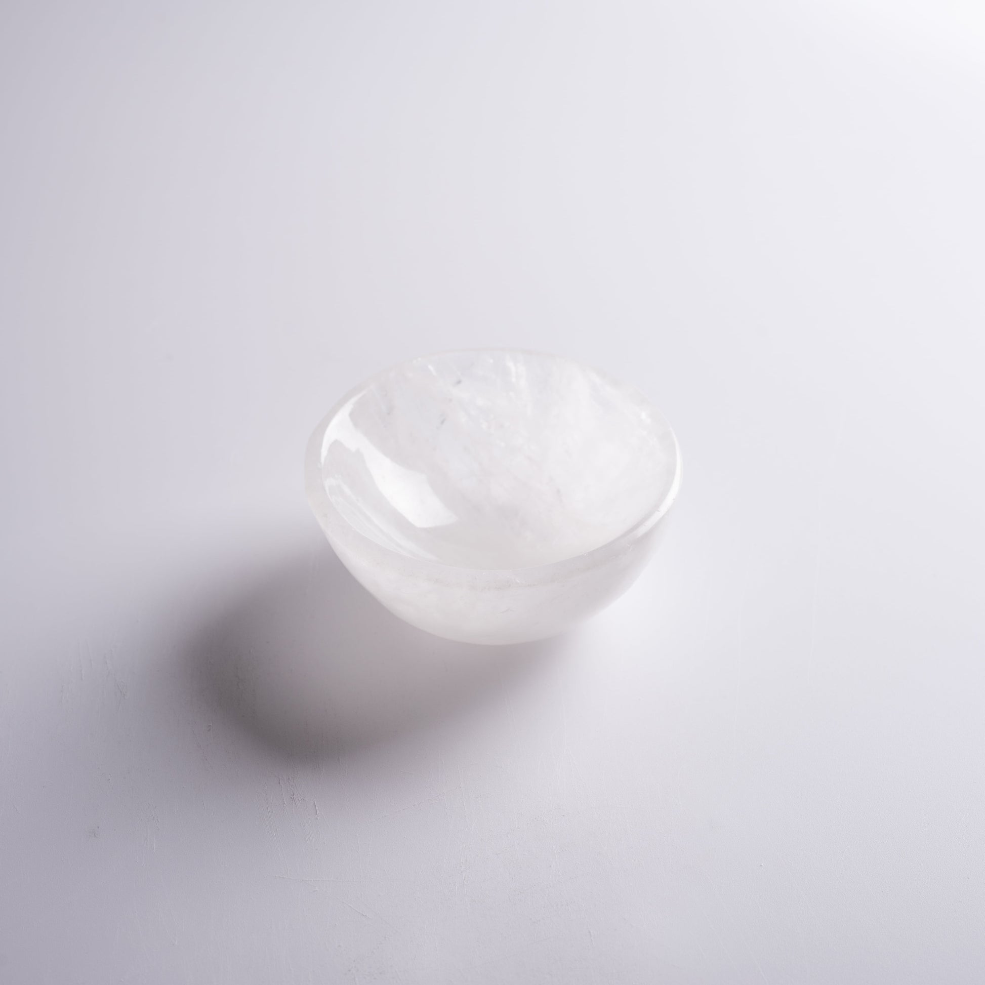 Small crystal bowl displayed in sacred space, used for rituals and offerings.