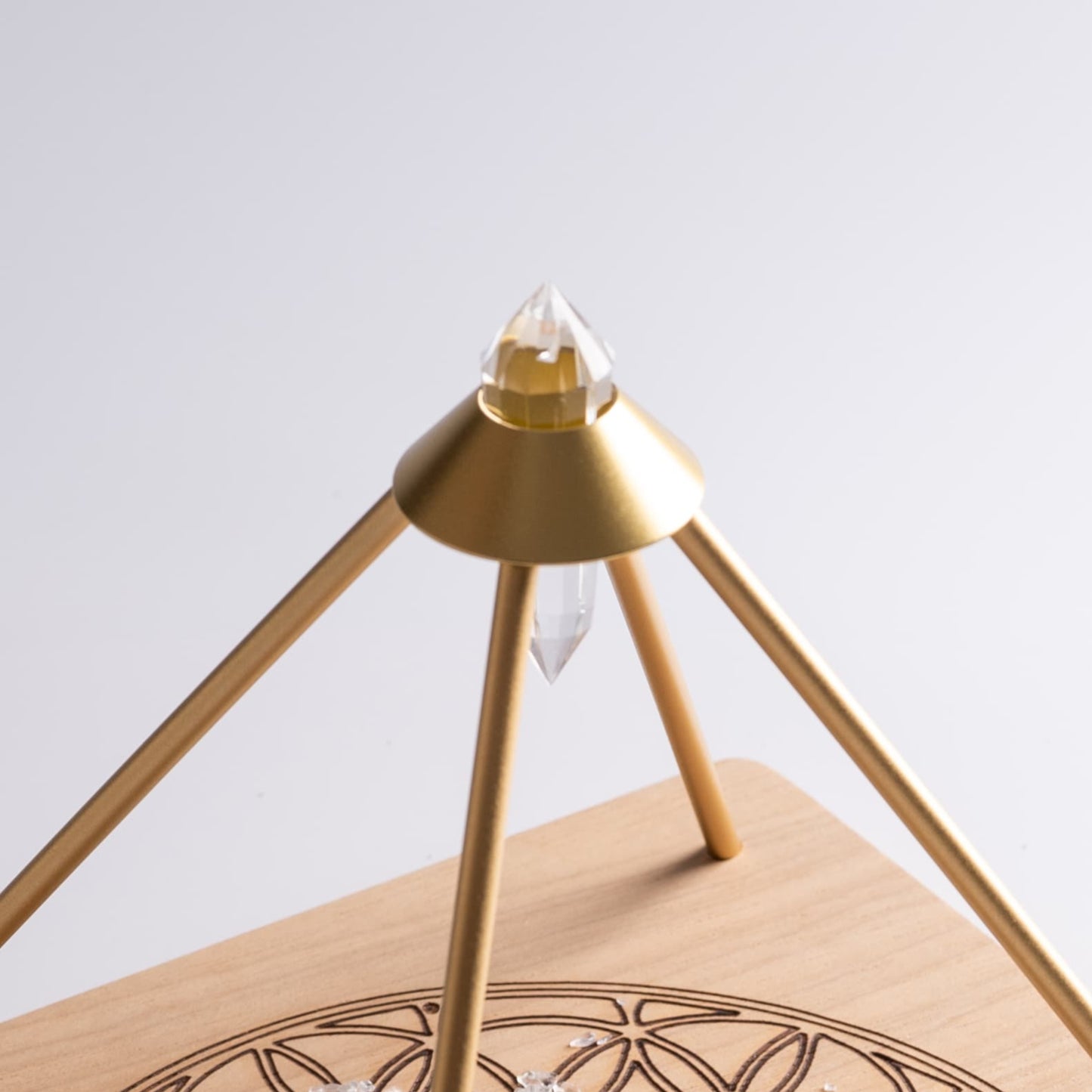 Vogel Crystal Grid Pyramid Stand with wooden base and gridding crystals.